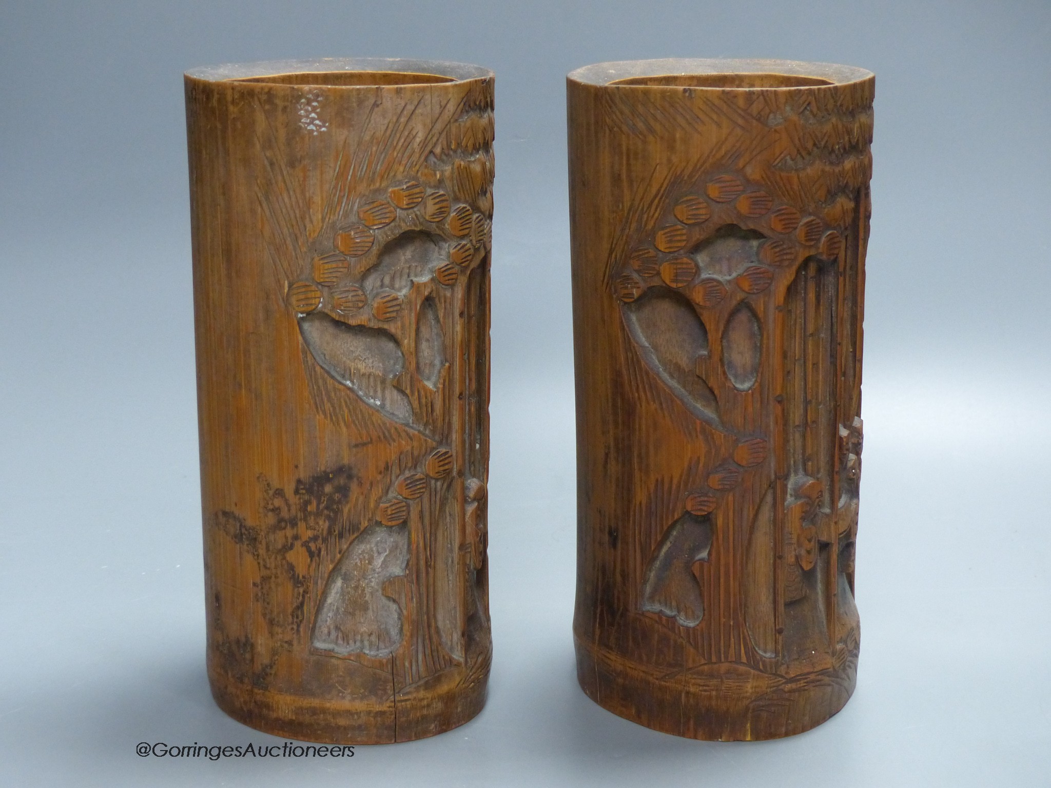 A pair of Chinese bamboo brush pots, carved with figures, signed to bases, height 21.5cm